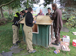 Freiwillige streichen ein Gartenhaus